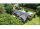 Expansive aerial view of a charming home with a pool, spacious yard, mature trees, and outbuildings at 1305 Creekview Dr, Gastonia, NC 28052
