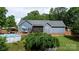 Spacious backyard featuring a large deck, a pool, and mature landscaping at 1305 Creekview Dr, Gastonia, NC 28052