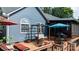 Relax on this spacious backyard deck featuring a swing, lounge seating, and umbrella at 1305 Creekview Dr, Gastonia, NC 28052