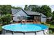 Backyard featuring an above ground pool and a spacious deck with outdoor seating at 1305 Creekview Dr, Gastonia, NC 28052