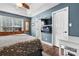 Comfortable bedroom featuring a stylish bed, mounted TV, and a window, creating a cozy and inviting space at 1305 Creekview Dr, Gastonia, NC 28052