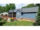 View of the home's exterior showcasing a screened porch, wooden deck, and beautifully maintained lawn at 1305 Creekview Dr, Gastonia, NC 28052