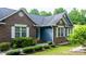 Charming home exterior with brick and siding, complemented by neat landscaping, window shutters and an inviting entryway at 1305 Creekview Dr, Gastonia, NC 28052