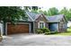 Side view of a home featuring a brick and siding exterior, showcasing a spacious driveway and attached garage at 1305 Creekview Dr, Gastonia, NC 28052