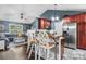 Modern kitchen area featuring a breakfast bar with seating, hardwood floors, stainless steel appliances and sleek countertops at 1305 Creekview Dr, Gastonia, NC 28052