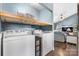 Functional laundry room with modern appliances and a convenient shelf, blending practicality with home design at 1305 Creekview Dr, Gastonia, NC 28052