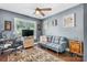 Functional office space with a sofa, desk, and ample light, creating a comfortable and productive work environment at 1305 Creekview Dr, Gastonia, NC 28052