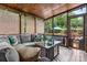 Relaxing screened porch with comfortable seating, a modern fire table, and views of the outdoor area, enhancing outdoor living at 1305 Creekview Dr, Gastonia, NC 28052