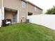 Well-maintained backyard with a privacy fence, lawn, and outdoor seating area at 13422 Calloway Glen Dr, Charlotte, NC 28273