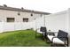 Green backyard area enclosed by a white privacy fence, complemented by outdoor seating at 13422 Calloway Glen Dr, Charlotte, NC 28273