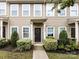 A closer view of the townhome's exterior, highlighting the dark front door with a 'WELCOME' sign and neat landscaping at 13422 Calloway Glen Dr, Charlotte, NC 28273