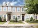 Charming townhome featuring a welcoming entrance with a dark front door and manicured landscaping at 13422 Calloway Glen Dr, Charlotte, NC 28273