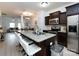 Modern kitchen with a granite island, stainless steel appliances, and an open view to the living room at 13422 Calloway Glen Dr, Charlotte, NC 28273