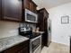 Well-equipped kitchen with stainless steel appliances, granite countertops, and modern dark wood cabinetry at 13422 Calloway Glen Dr, Charlotte, NC 28273