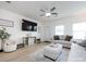 A comfortable living room with ample seating, a decorative media center, and lots of natural light at 13422 Calloway Glen Dr, Charlotte, NC 28273