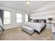 Bright main bedroom with a large bed, neutral decor, and plenty of natural light from multiple windows at 13422 Calloway Glen Dr, Charlotte, NC 28273