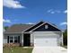 Charming single-story home featuring stone accents, gray siding, and a two-car garage at 1522 Doran Ter, Richburg, SC 29729