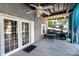 Back patio area of the house with a ceiling fan and backyard storage for a golf cart at 161 Badin Lake Cir, New London, NC 28127