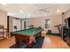 Finished basement area with a pool table, exercise equipment, and a bar at 161 Badin Lake Cir, New London, NC 28127