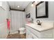 Traditional bathroom with modern fixtures, vanity, and shower with patterned curtain at 161 Badin Lake Cir, New London, NC 28127