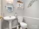Updated half bath features a pedestal sink, and decorative wall art at 161 Badin Lake Cir, New London, NC 28127