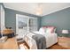 Sunny bedroom with wood floors, a large window, and a light fixture at 161 Badin Lake Cir, New London, NC 28127
