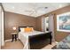 This bedroom features carpeted floors, dark wood furniture, and a ceiling fan at 161 Badin Lake Cir, New London, NC 28127