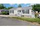 Charming single-story home with white siding, black shutters, and well-maintained landscaping at 161 Badin Lake Cir, New London, NC 28127