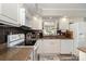 Well-lit kitchen featuring white cabinets, updated appliances, and granite countertops at 161 Badin Lake Cir, New London, NC 28127