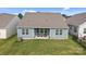 This backyard view showcases the covered patio and well-maintained green space at 161 Pampas Pl, Statesville, NC 28625