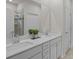 Bathroom featuring double vanity with quartz countertop, large mirror, and tiled walk-in shower at 161 Pampas Pl, Statesville, NC 28625
