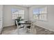 Cozy breakfast nook with a round table, four chairs, and natural light from two large windows at 161 Pampas Pl, Statesville, NC 28625