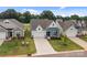 Beautiful curb appeal with blue and white exterior, attached garage, and green lawn at 161 Pampas Pl, Statesville, NC 28625