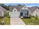 Charming exterior with blue siding, white accents, and well-manicured lawn in a suburban neighborhood at 161 Pampas Pl, Statesville, NC 28625