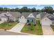 Attractive exterior featuring blue siding, white accents, attached garage, and lush lawn at 161 Pampas Pl, Statesville, NC 28625