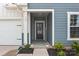 Inviting covered front entry with 'FRIENDS' decor, flanked by tidy landscaping and a glimpse of the attached garage at 161 Pampas Pl, Statesville, NC 28625