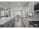 Open concept kitchen showcases an island with quartz countertops, pendant lights, and an eat-in kitchen at 161 Pampas Pl, Statesville, NC 28625