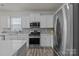 Bright kitchen features stainless steel appliances, gray subway tile backsplash, and light countertops at 161 Pampas Pl, Statesville, NC 28625