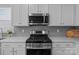 The modern kitchen features stainless appliances, a gas range, and sleek countertops at 161 Pampas Pl, Statesville, NC 28625