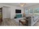 Spacious living room with wood-look flooring, ample seating, and large windows, perfect for relaxing at 161 Pampas Pl, Statesville, NC 28625