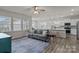 Bright, open-concept living room featuring a cozy sofa and seamless flow to the kitchen at 161 Pampas Pl, Statesville, NC 28625