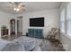 Bright living area with stylish wood-look flooring, a large TV, and comfortable seating arrangements at 161 Pampas Pl, Statesville, NC 28625