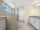 Bright bathroom featuring a tiled shower with glass door, double sinks with granite counters, and great natural light at 163 W Heart Pine Ln, Statesville, NC 28677
