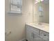 Bright bathroom featuring a single vanity and a large mirror over the sink at 163 W Heart Pine Ln, Statesville, NC 28677