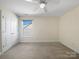 Bedroom with neutral walls and carpet and a window with a backyard view at 163 W Heart Pine Ln, Statesville, NC 28677