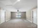 Spacious bonus room with neutral carpet and walls with two entry doors at 163 W Heart Pine Ln, Statesville, NC 28677