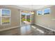 Bright dining area with sliding glass doors and large windows, providing ample natural light and views of the backyard at 163 W Heart Pine Ln, Statesville, NC 28677
