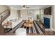 Bright living room features a ceiling fan, fireplace, large picture window, and contemporary furniture set with striped accents at 163 W Heart Pine Ln, Statesville, NC 28677