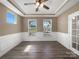 An open living space features beautiful molding, luxury vinyl flooring, and large windows for ample natural light at 163 W Heart Pine Ln, Statesville, NC 28677