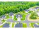 Aerial view of home in a neighborhood surrounded by lush green trees and well manicured lawns at 1702 Batson Creek Ln, Weddington, NC 28104